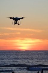 Naklejka na ściany i meble Drone quadcopter at sunset