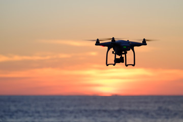 Fototapeta na wymiar Drone quadcopter at sunset