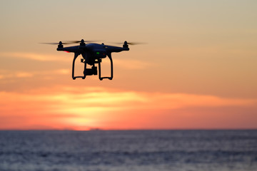 Obraz na płótnie Canvas Drone quadcopter at sunset