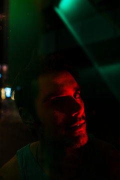 Agressive crazy man at night with city lights