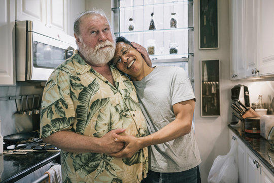 Portrait of couple standing in kitchen