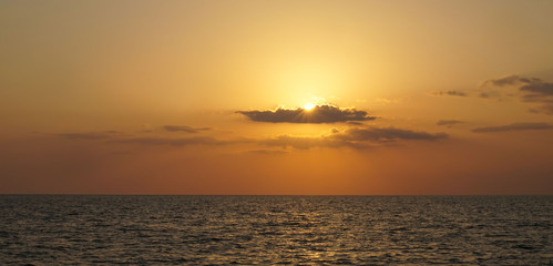 Naples,Florida,USA-05/26/2019. A sunset on the Gulf of Mexico. Horizon line of the water.