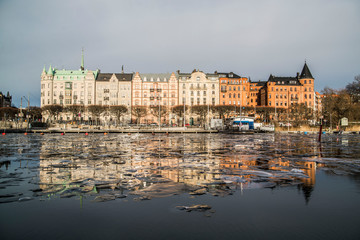 reflection of colorful houses on ice in stockholm sweden