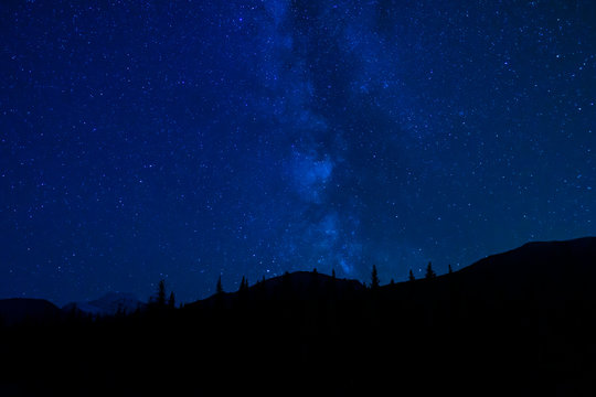 Blue Night Sky Stars And Milky Way In Mountain Scene