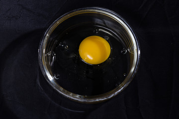 Raw egg in a glass plate
