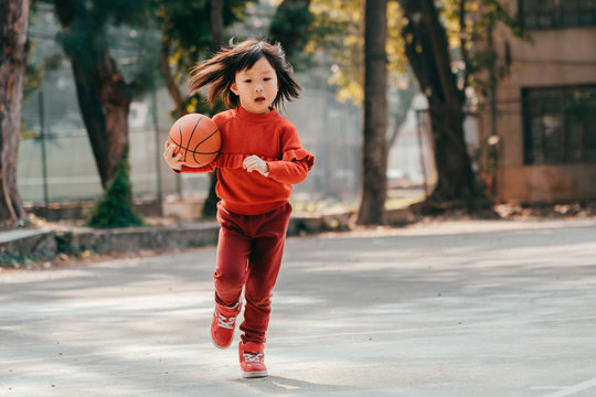 child playing basketball outdoor