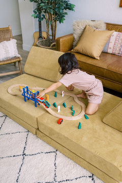 Child playing with toy train set