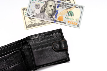 old and new hundred dollar bills and black wallet on a white background