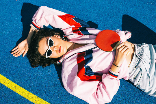 Portrait of Cool Female Teenager Lying on Her Back in Sun