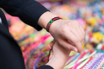 trying on colorful handicraft bracelet