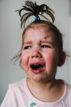 Naklejki Crying Toddler Girl with Funny Topknot