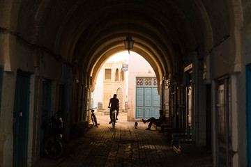 Fototapeta na wymiar silhouette of a biker in old town tunisia