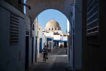 biker in a tunnel in old town medina tunisia