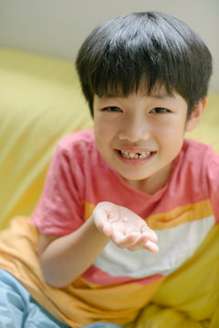 Little boy losing his front tooth