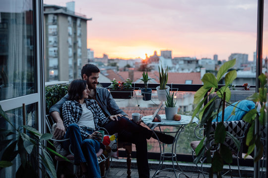 Cute couple looking at table computer on the house terrace