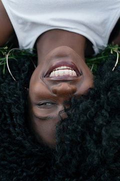 Portrait of gorgeous african girl laying on the grass