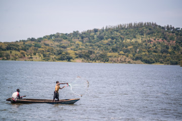 Fototapeta na wymiar fisherman casting his net on lake victoria uganda