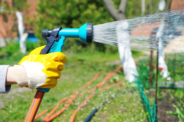 Watering spray gun in a hand