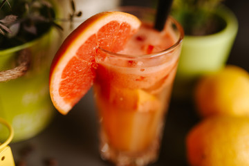 Close up of glass of grapefruit juice on a table