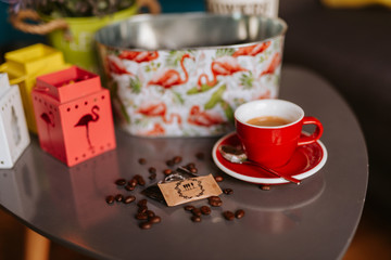 Close up of red cup of espresso coffee on the table