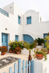 Fototapeta na wymiar White house with blue windows and doors in Santorini, Greece