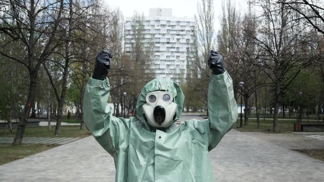 A man in a protective suit holds an imaginary sign for the inscription. Social protest.