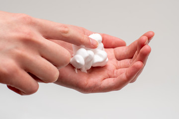 close up foam in two hands, isolated on white background, palm touch foam. Cleanliness and body care concept