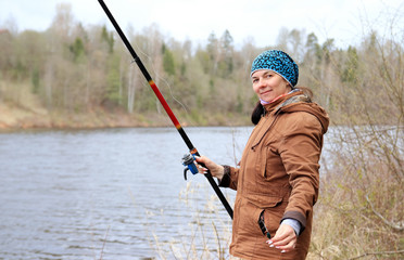 woman with fishing rod on the river