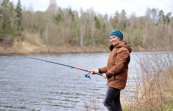 Woman With Fishing Rod On The River