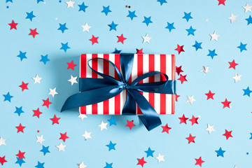 Obraz premium 4th of July American Independence Day. Happy Independence Day. Red, blue and white star confetti, decorations on blue background. Flat lay, top view, copy space