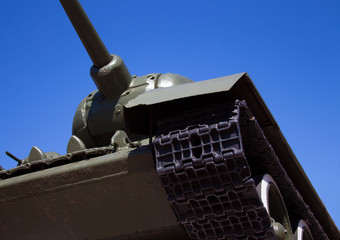 Fototapeta na wymiar Tank T 34 against the blue sky stands on the podium. Monument of World War II of the legendary victory tank 34