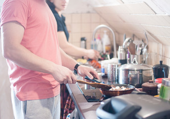 Quarantined life. A man is cooking food. Makes the grill