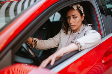 Attractive young caucasian woman driving a car
