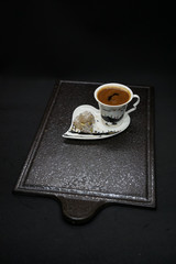 traditional Turkish coffee with Turkish delight. heart shaped saucers and traditional Turkish coffee on black granite   tray in black background. Coffee cups and saucers with the symbols of istanbul.