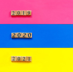 Blue, pink, yellow paper background with conceptual text: 