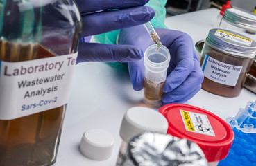 Scientific analysis of wastewater sample in laboratory, investigation of possible contamination by Sars-Cov-2 in humans, conceptual image