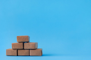Cardboard boxes with groceries or other purchases on blue background.