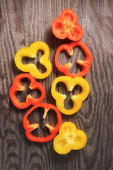 Red pepper, sliced, lie on a wooden board, rustic kitchen