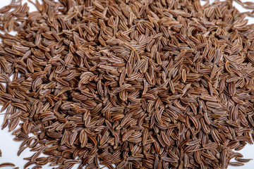 Pile of cumin seeds isolated on white background