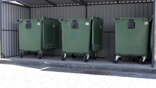 three plastic green trash cans for separated garbage. concept of environment protection and technology of recycling