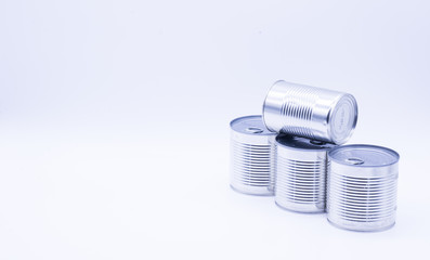 Donation with four cans of canned food on white, peas and corn, food stock for quarantine, isolation period on white. Donation, coronavirus