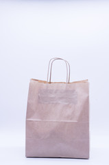  Brown paper bag for donation on white background. Food supplies, food stock for quarantine, isolation period on white. Donation, coronavirus 