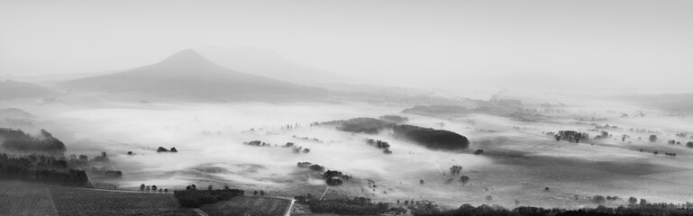 Black and white morning landscape with fog of a mountain