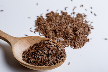 Pile of cumin seeds isolated on white background
