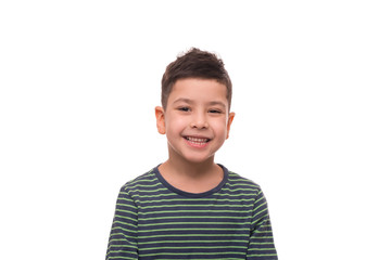 Shot of young positive boy wearing  green striped shirt, isolated