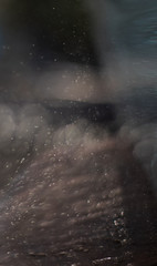 Small drops of water beaten by the sun in the counter-jour form gray abstractions