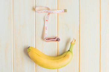 Banana with tape to measure the figure. Weight loss, healthy eating and slim body concept. Banana...