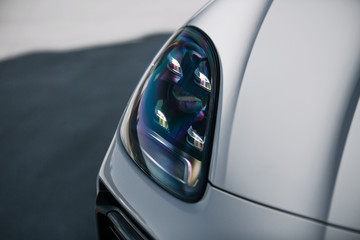 Headlight of modern luxury supercar. Close up detail shot