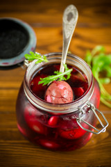 marinated chicken eggs in beetroot marinade in a glass jar