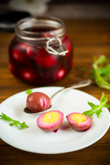 marinated chicken eggs in beetroot marinade in a plate